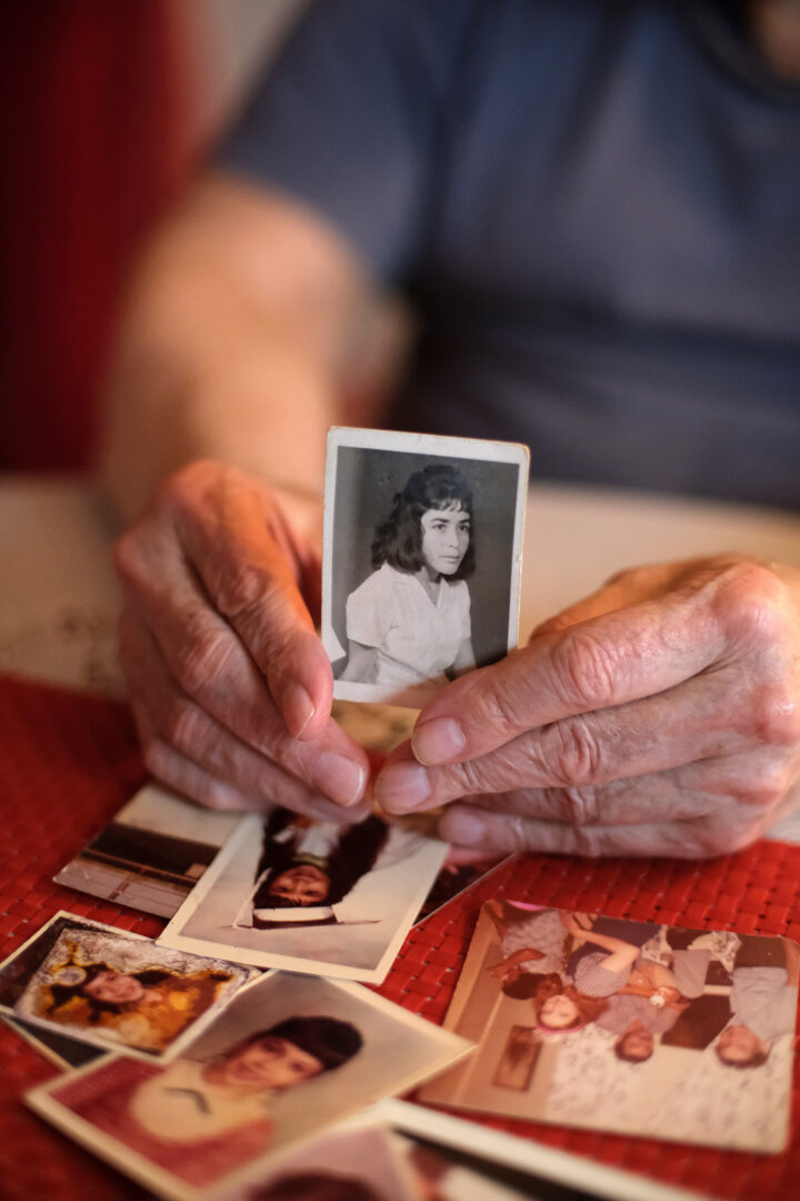 Person holding black and white photo of a woman.