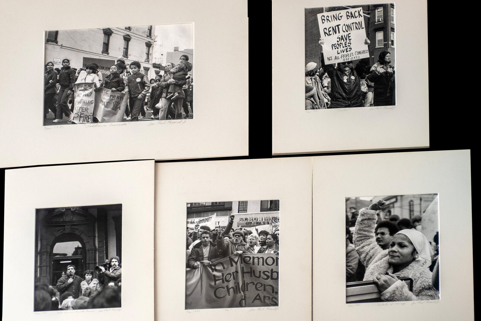 5 black and white photos in white frames.