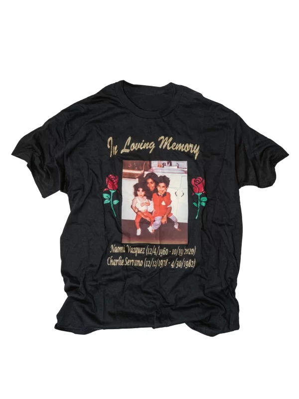 Black t-shirt with text "in loving memory" against white backdrop.