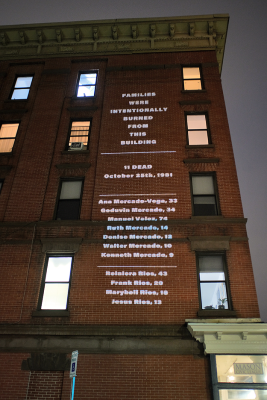 Building with a projection of the list of people who were burned from this building fire.
